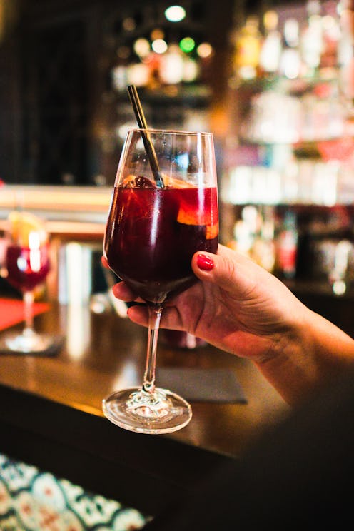 Holding a wineglass with Sangria at a Tapas Bar