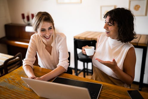 Young Caucasian businesswomen working together at the modern coffee shop