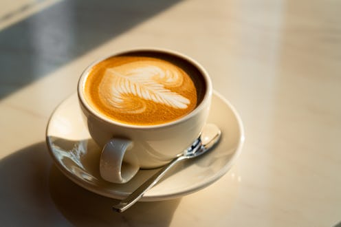 Feshly brewed latte coffee on a white table, a coffee drink made with espresso and steamed milk.