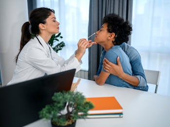 A black boy during a medical nose swab test at the hospital