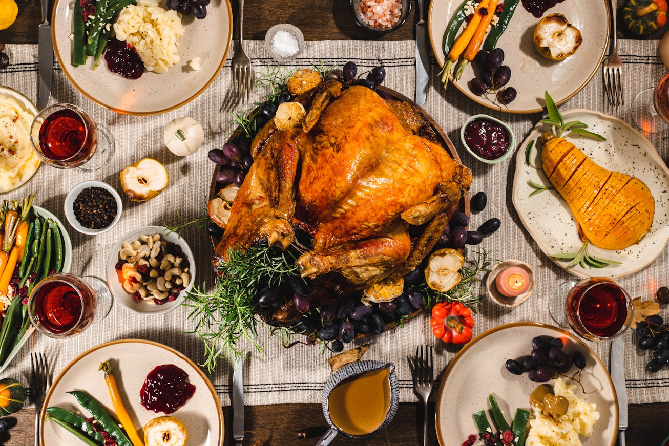 Directly above view of a traditional Thanksgiving meal with roasted turkey on the dinner table. Roas...