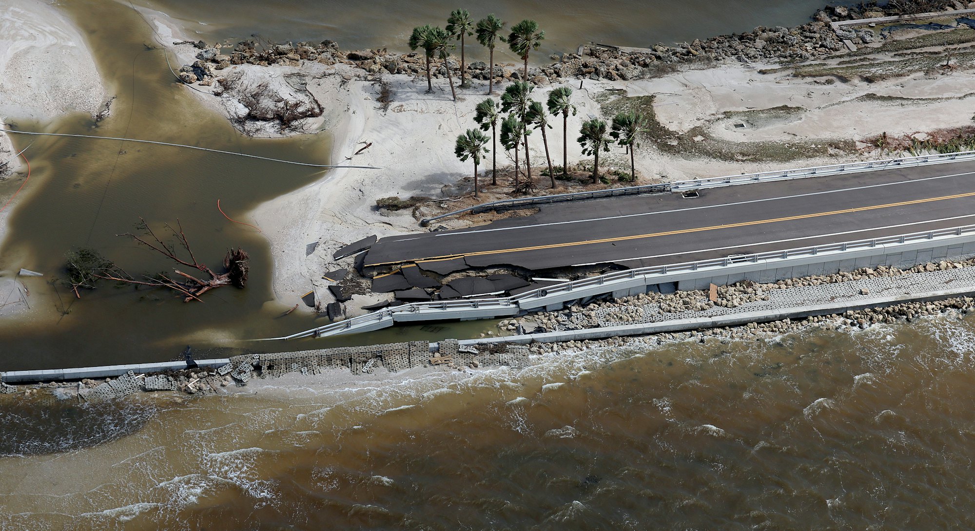 SANIBEL, FLORIDA - SEPTEMBER 29: In this aerial view, parts of Sanibel Causeway are washed away alon...