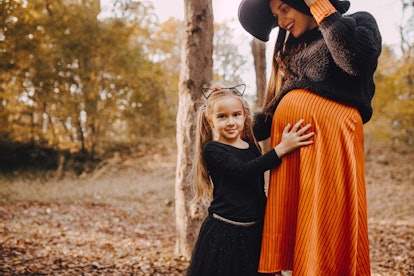 Daughter and her mom ready for the Halloween in an article about can pregnant women go to haunted ho...