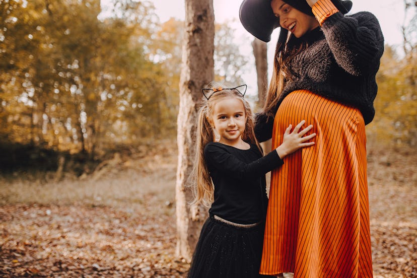 Daughter and her mom ready for the Halloween in an article about can pregnant women go to haunted ho...