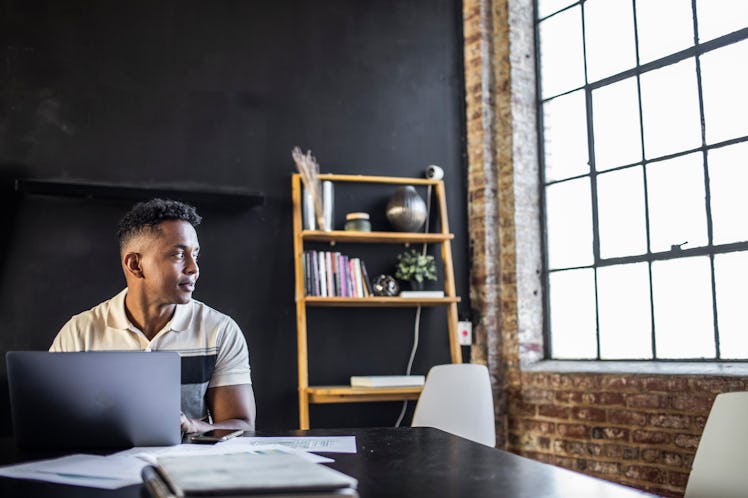 Young professional man working in modern office space