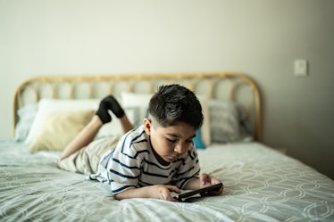 Child boy using smart phone at home