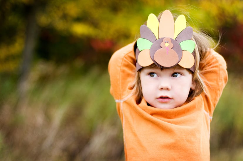 Little boy with a Turkey hat for thanksgiving in a round up of thanksgiving poems for kids