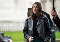 Alexa Chung wears a black leather jacket during London Fashion Week