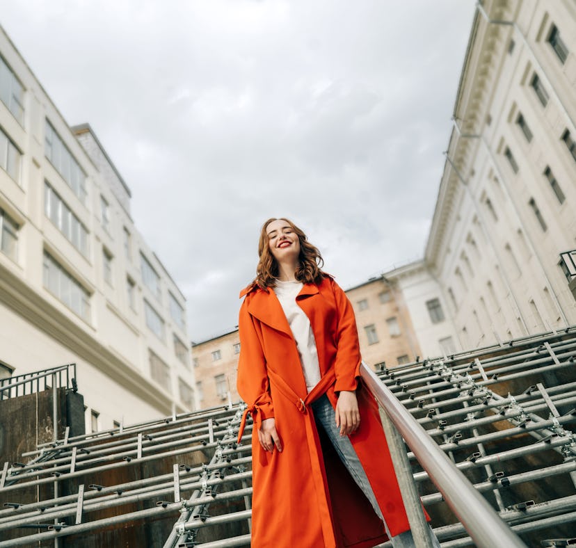 Young woman laughing as she reflects on the spiritual meaning of the October 2022 blood moon.