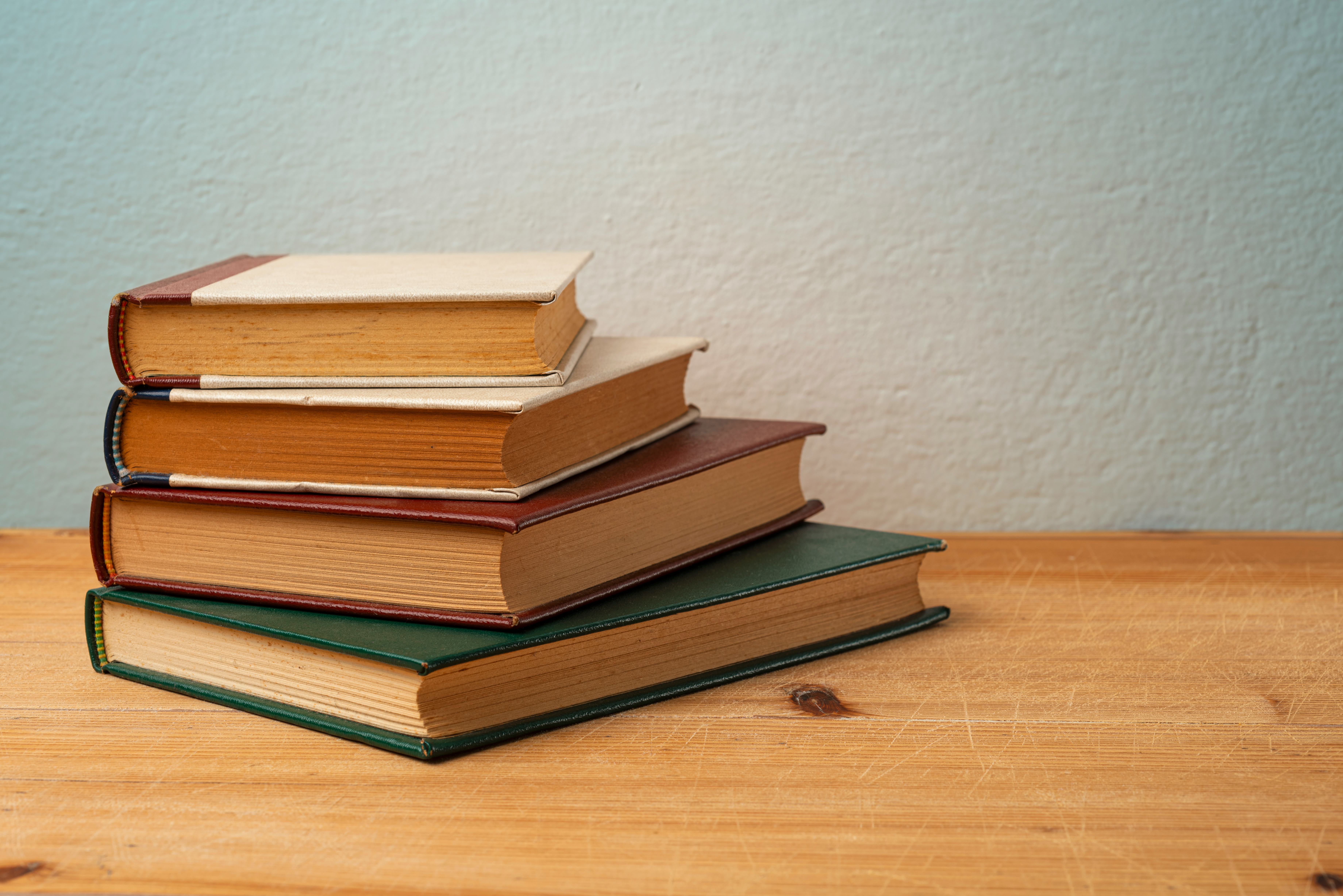 A Stack of Old Hardcover Books On Wooden Table.Studio Shot