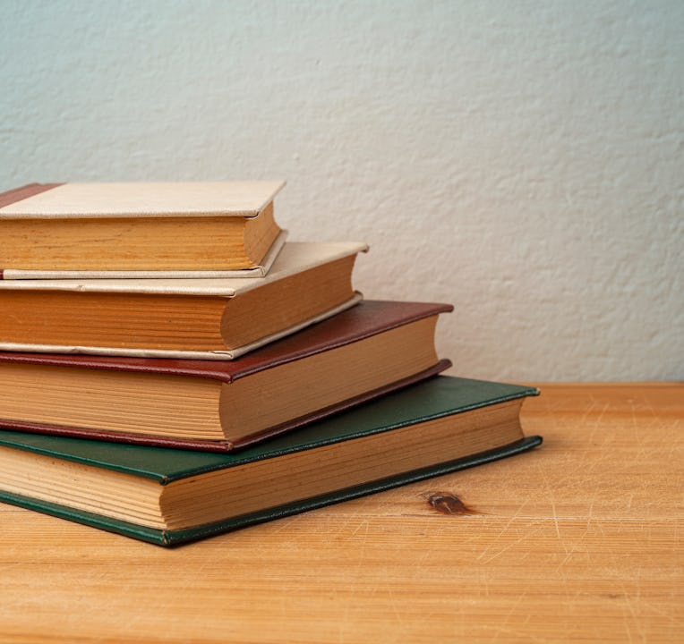 A Stack of Old Hardcover Books On Wooden Table.Studio Shot