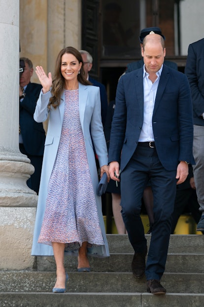 Kate Middleton wearing a long blue coat.