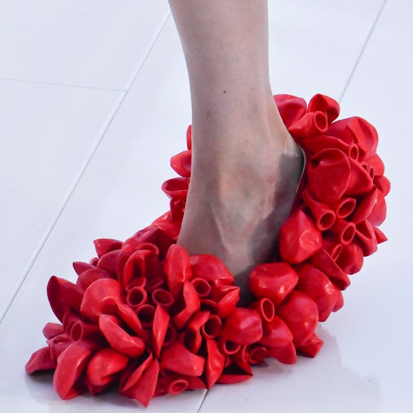 A model walks the runway wearing frills shoe trend during the Loewe Ready to Wear Spring/Summer 2023...