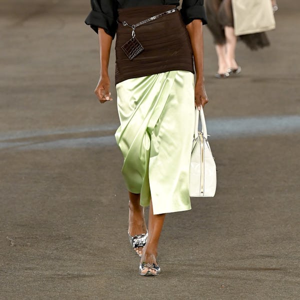 A model walks the runway wearing the silver shoe trend during Tory Burch - Spring/Summer 2023 New Yo...