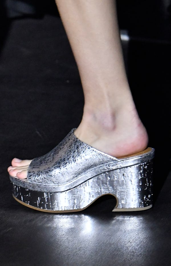 A model walks the runway wearing the silver shoe trend during the Chloe Ready to Wear Spring/Summer ...