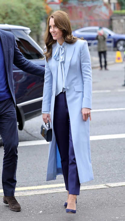 Kate Middleton wearing a long blue coat.