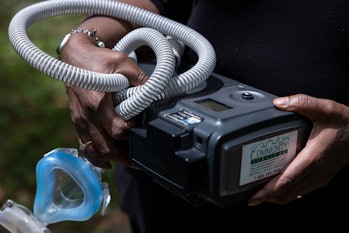 Jenny Shields poses for a photo with her CPAP machine, which was recalled for safety reasons, at her...