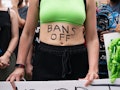 ATLANTA, GA - JUNE 25: A woman with 'Bans Off' written on her body is seen during a protest against ...