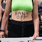 ATLANTA, GA - JUNE 25: A woman with 'Bans Off' written on her body is seen during a protest against ...