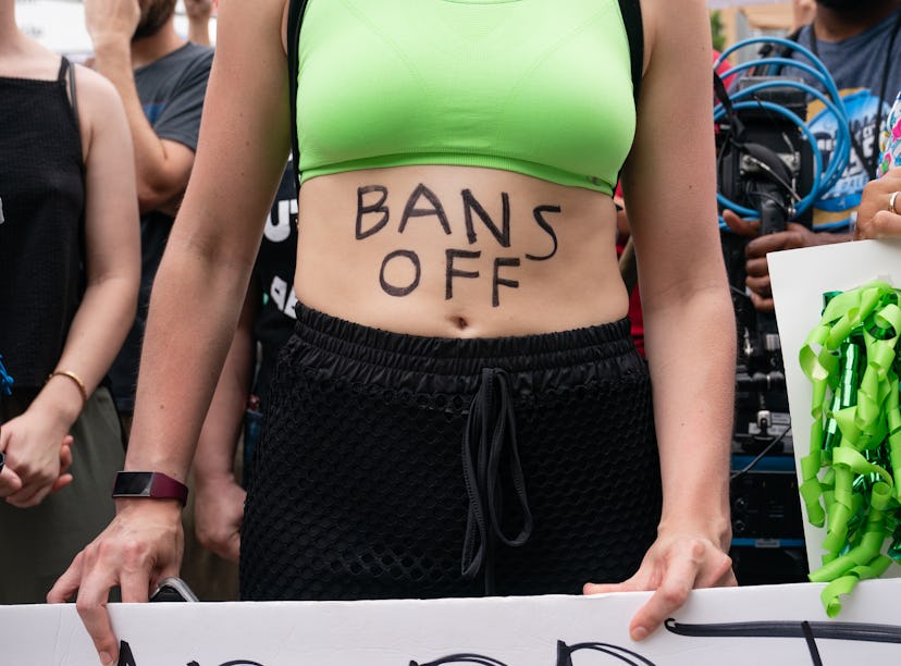 ATLANTA, GA - JUNE 25: A woman with 'Bans Off' written on her body is seen during a protest against ...