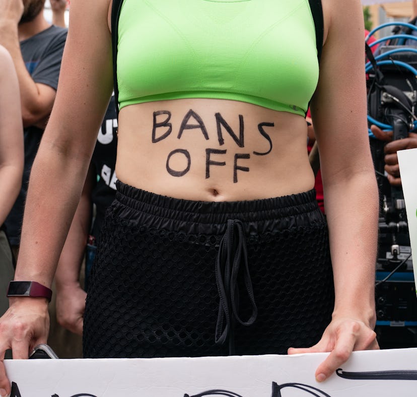 ATLANTA, GA - JUNE 25: A woman with 'Bans Off' written on her body is seen during a protest against ...