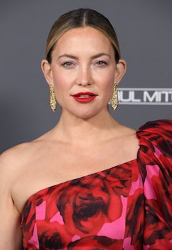 Kate Hudson wearing a red floral dress.