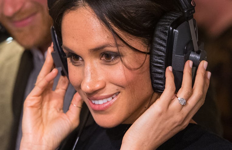 LONDON, ENGLAND - JANUARY 09: Meghan Markle listens to a broadcast through headphones at Reprezent 1...