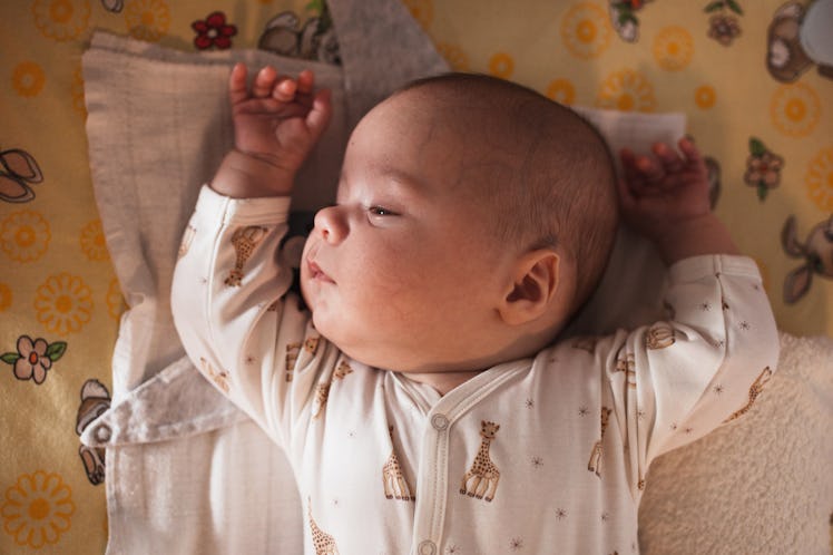 Close-up of a newborn baby napping in a crib