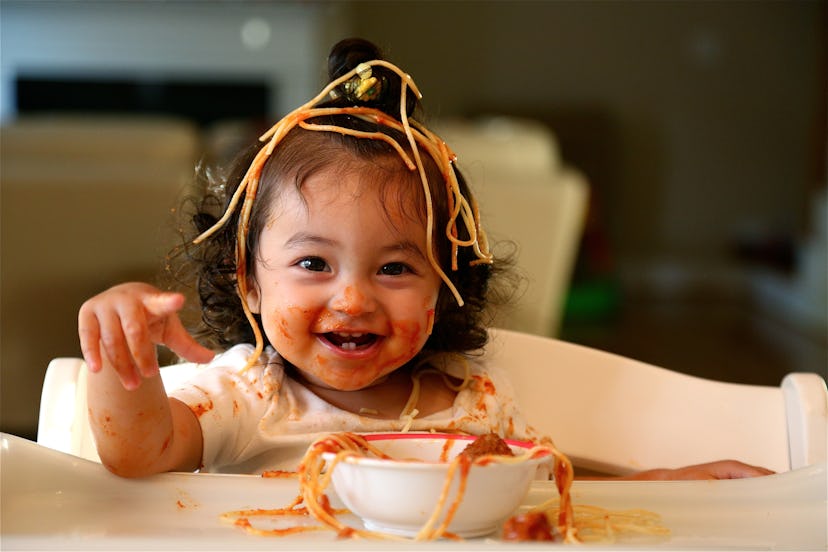  cute little girl eating spaghetti in a round up of baby girl names Scorpio baby girl names