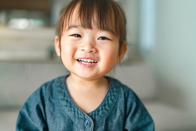 A portrait of a small girl in the living room at home in a list of girl names that start with H