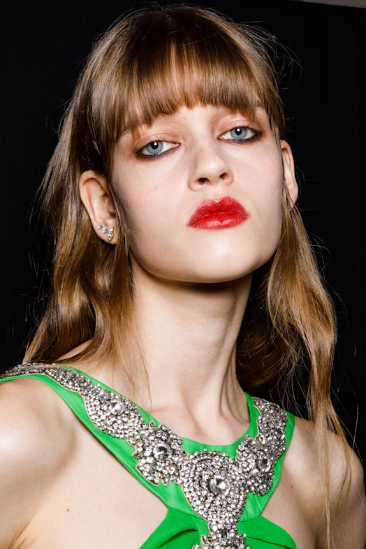 A model wearing lip liner and lip stain, the 2022 holiday beauty trend for Virgo