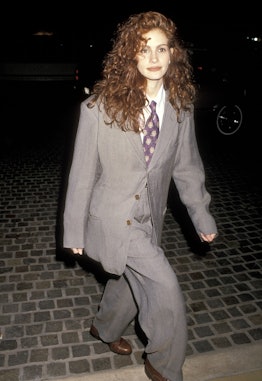 Julia Roberts wearing an oversized gray suit in the '90s.