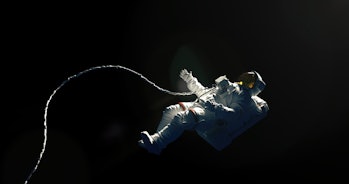 Asronaut on a black background hovering in an outer space. Astronaut in a space