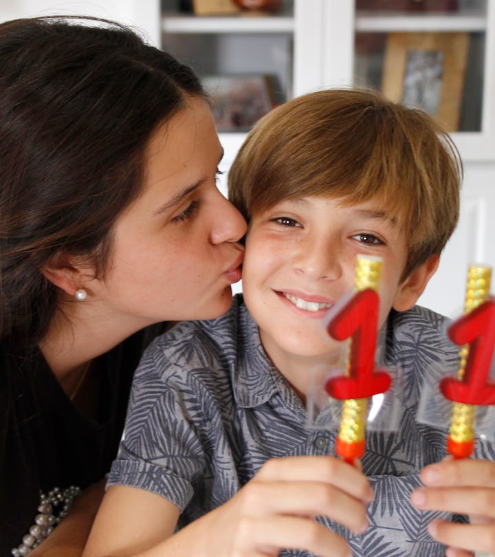 Teen girl kissing brother at birthday celebration