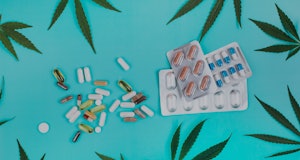 Set of pills and blister packs with tablets made of cannabis on turquoise background with cannabis l...
