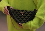 Sonia Lyson, bag detail, wearing Prada triangle olive black bag, Storets neon green oversized sweate...