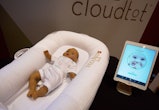 A DockATot Deluxe smart baby bed and app.