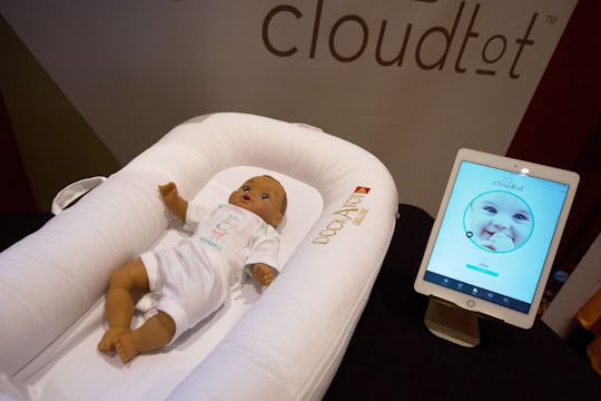 A DockATot Deluxe smart baby bed and app.