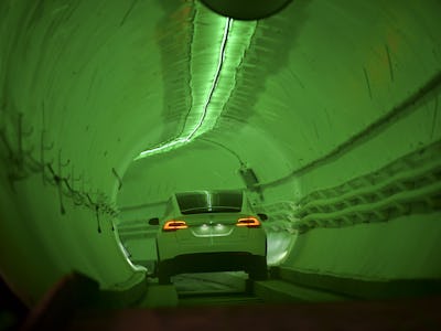 TOPSHOT - A modified Tesla Model X drives into the tunnel entrance before an unveiling event for the...