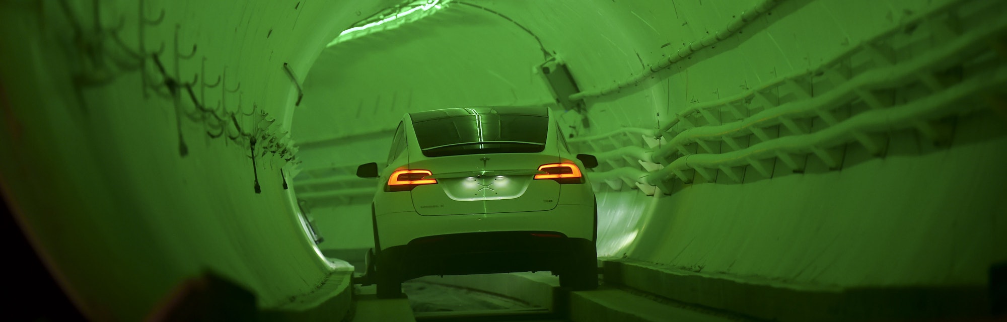 TOPSHOT - A modified Tesla Model X drives into the tunnel entrance before an unveiling event for the...