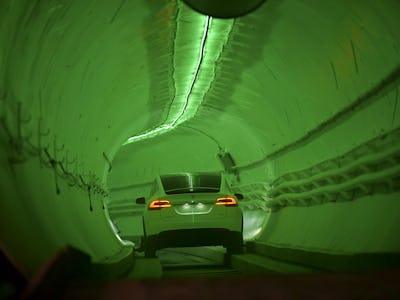 TOPSHOT - A modified Tesla Model X drives into the tunnel entrance before an unveiling event for the...