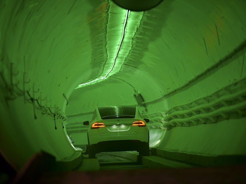TOPSHOT - A modified Tesla Model X drives into the tunnel entrance before an unveiling event for the...