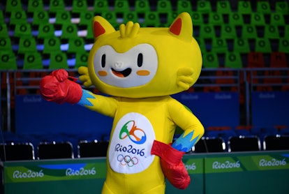 A fan dressed as the Olympic Games mascot, Vinicius, cheers ahead of a match during the Rio 2016 Oly...