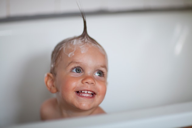 A toddler is being happy during a bath in a list of gaelic baby boy names