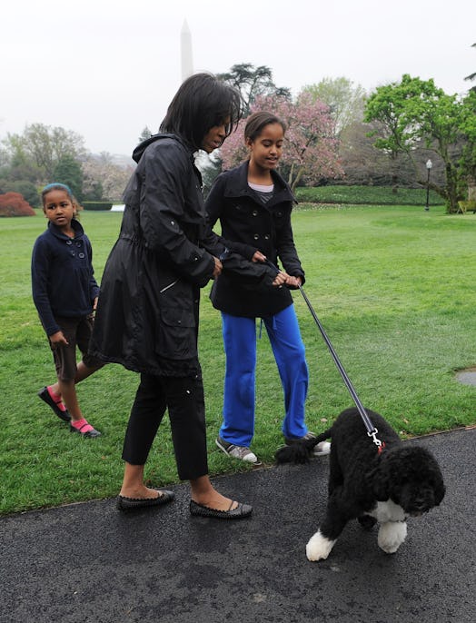 First Lady Michelle Obama and daughters Malia (R) and Sasha (L) walk.