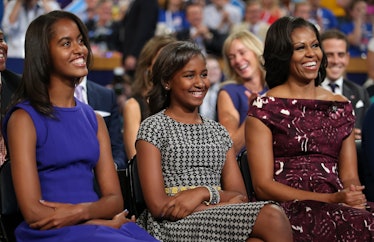 Malia Obama, Sasha Obama, and First lady Michelle Obama listen as Democratic presidential candidate,...