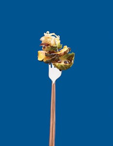 Brussel Sprout Recipe on Fork over Blue Background