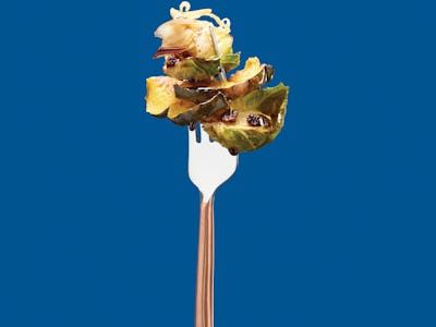 Brussel Sprout Recipe on Fork over Blue Background