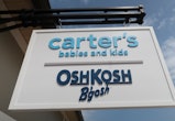 CENTRAL VALLEY, NY - AUGUST 26: A carters and OSH KOSHi sign hangs in front of their store at the Wo...