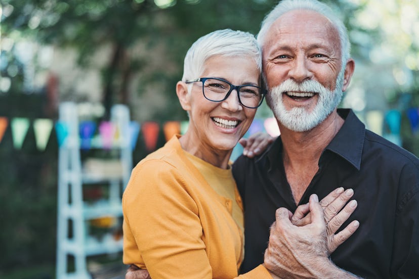 Happy senior couple embracing in a round up of love song quotes for instagram captions